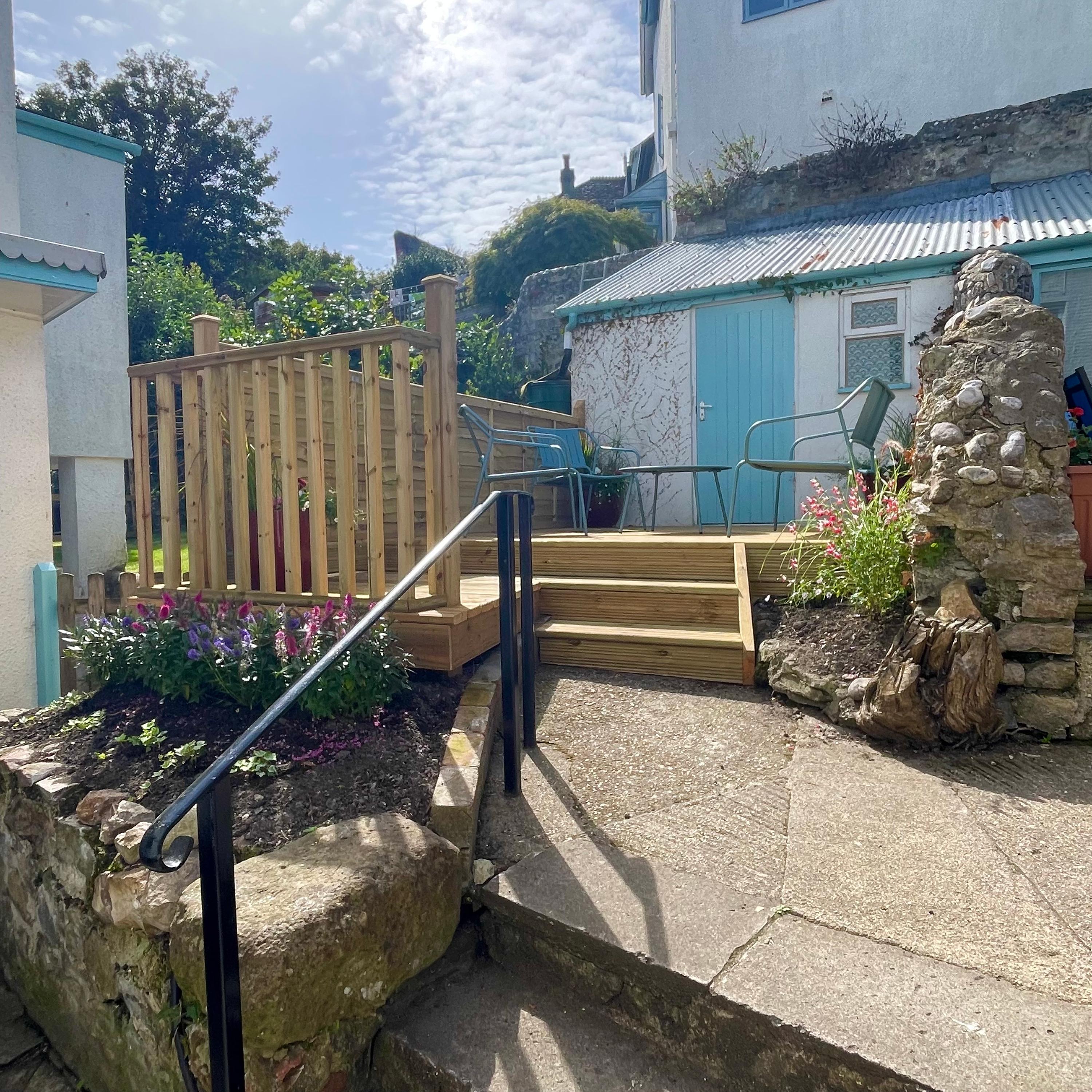 Courtyard private garden a few steps from the main front entracne of The Lyme Nook the perfect place for Al fresco eating and drinking on holiday here