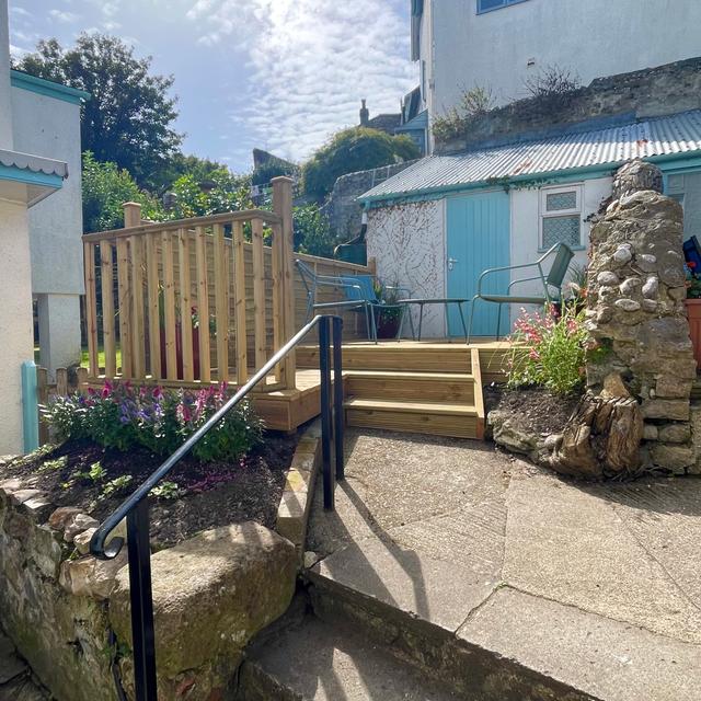 Courtyard private garden a few steps from the main front entracne of The Lyme Nook the perfect place for Al fresco eating and drinking on holiday here