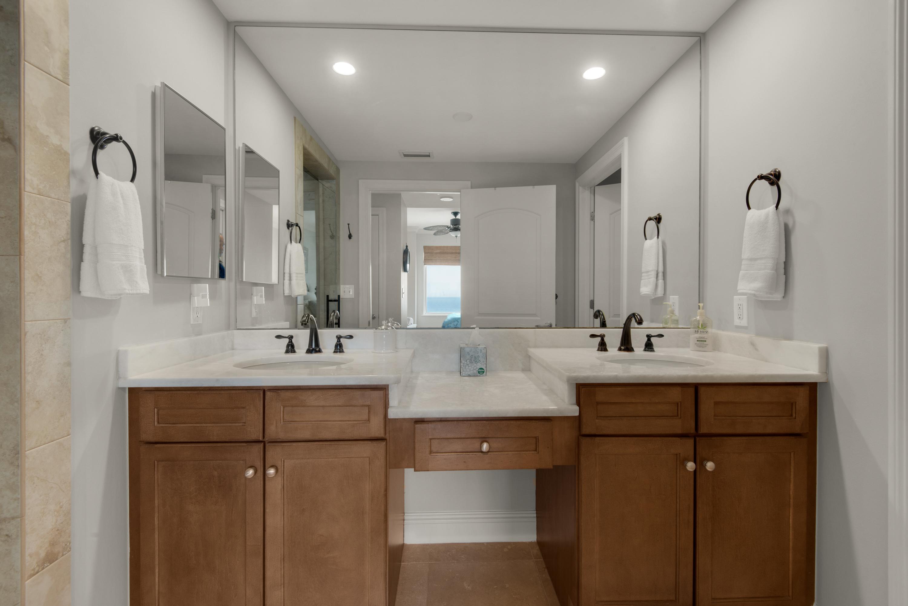Master bath with double vanities and white quartz countertops