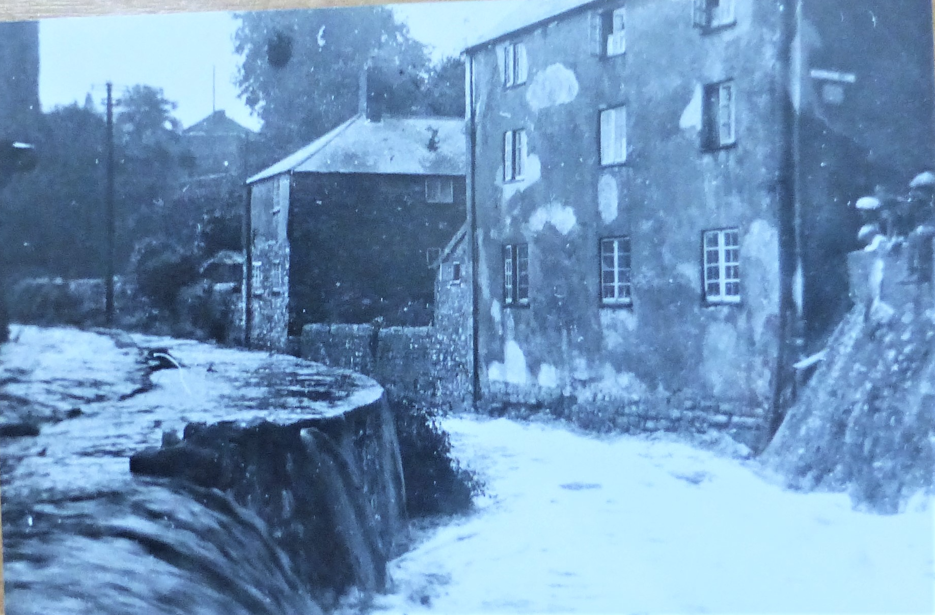 Waterside holiday property as it was 300 years ago showing the river running past and the the grand building where Waterside is a two bedroom holiday property within these  walls over two floors