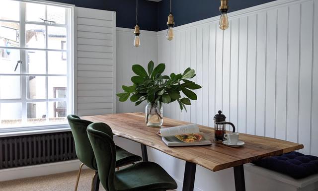 Hand crafted bench seating and bespoke cut and crafted wooden elm dining table with velvet chairs and over hanging lights this boutique and style centric design of this  dining space with river views flows throughout  the first floor of this deluxe holiday property  in Lyme Regis