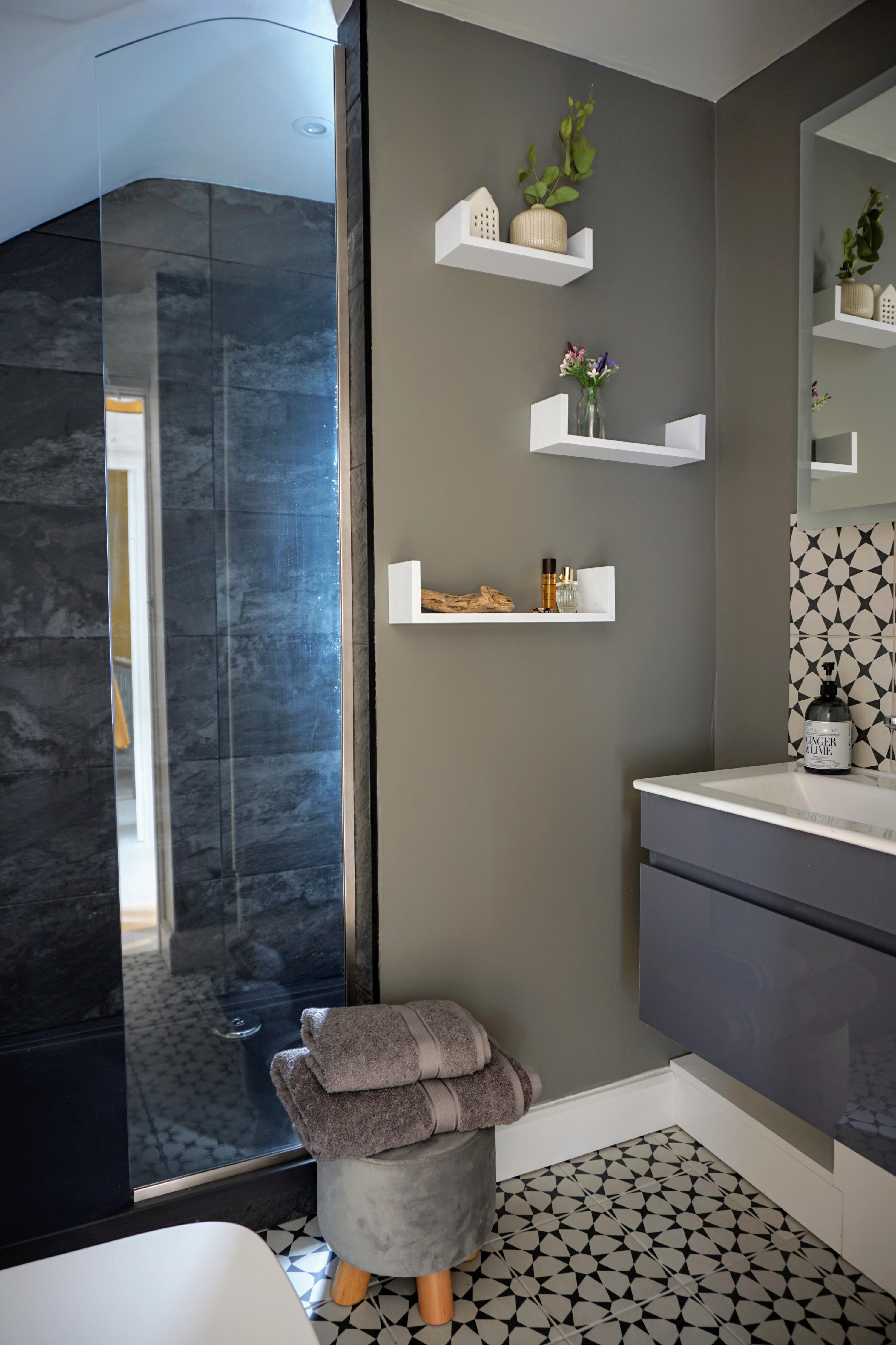 Modern and new  recently styled interior shower room with slate walls and muted colours with pretty tiles to make for a stylish shower room