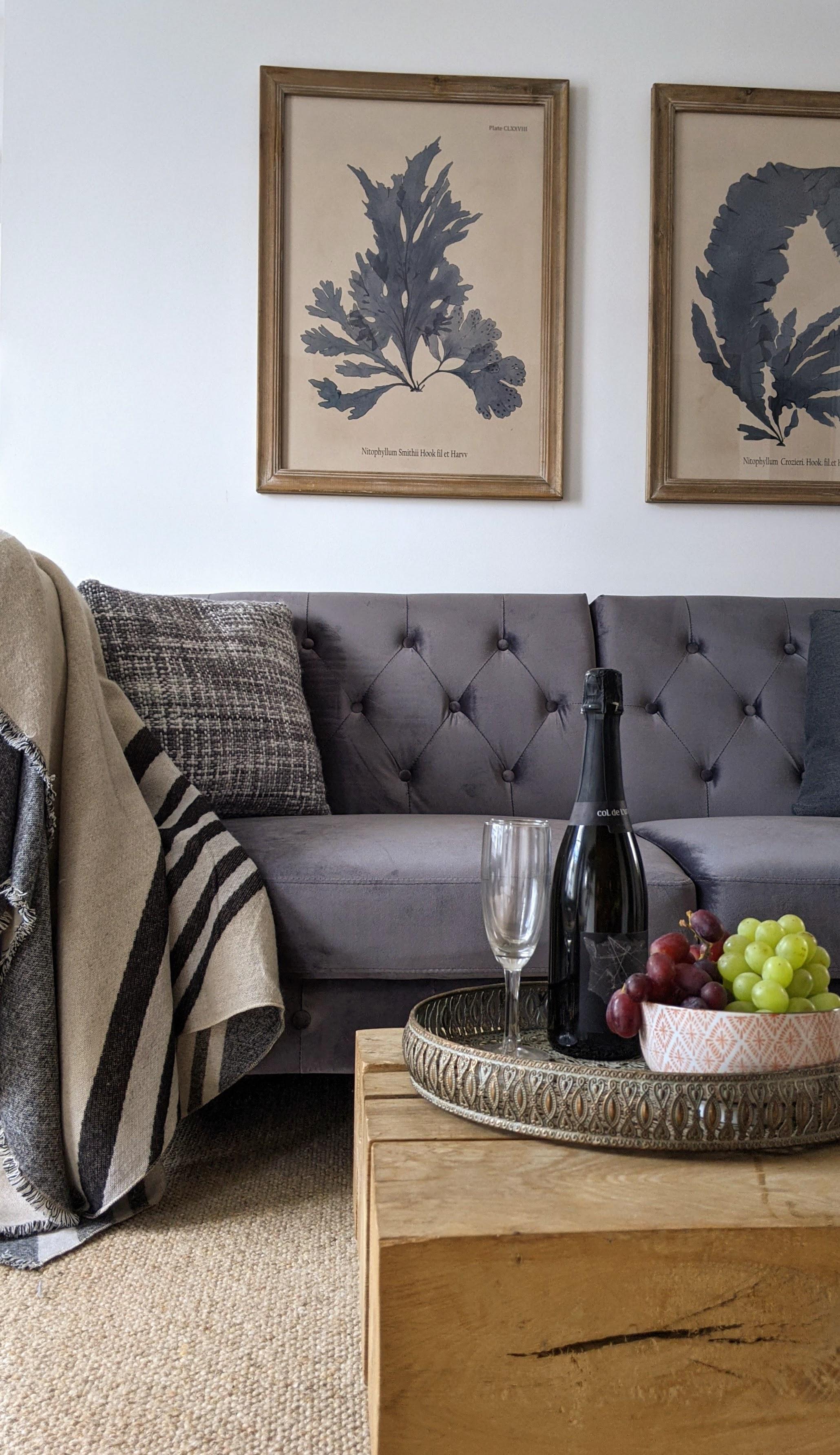 Open plan boutique holiday stay lounge with luxury sofa, wall art and low wooden coffee table grand designs style  