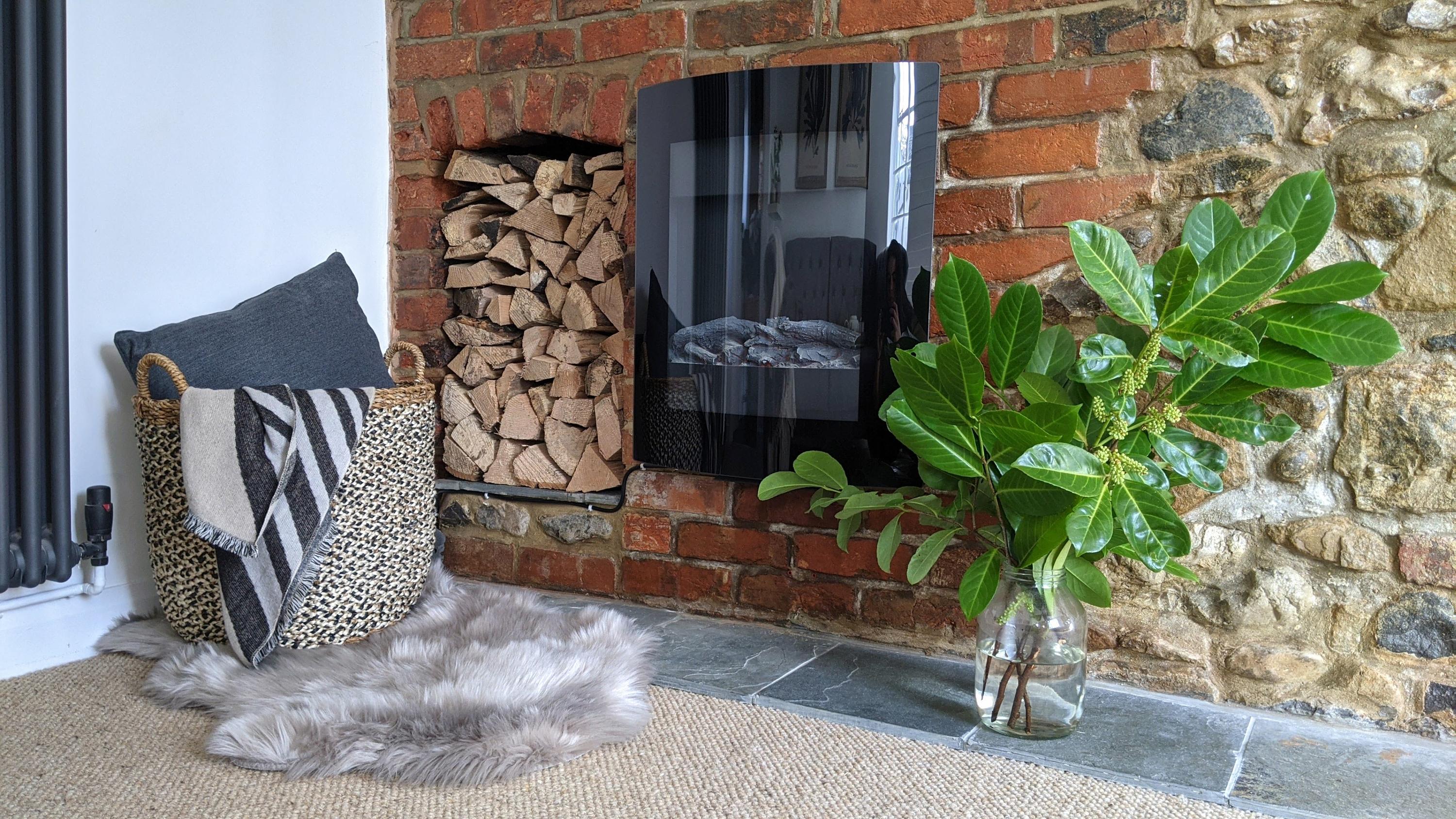 Lounge fire and period stone wall with Jurassic fossils in the wall as this centuries old holiday property sits on the Jurassic coast in Lyme Regis and enjoys a complete refurbishment of the interiors with luxury design style. Boutique