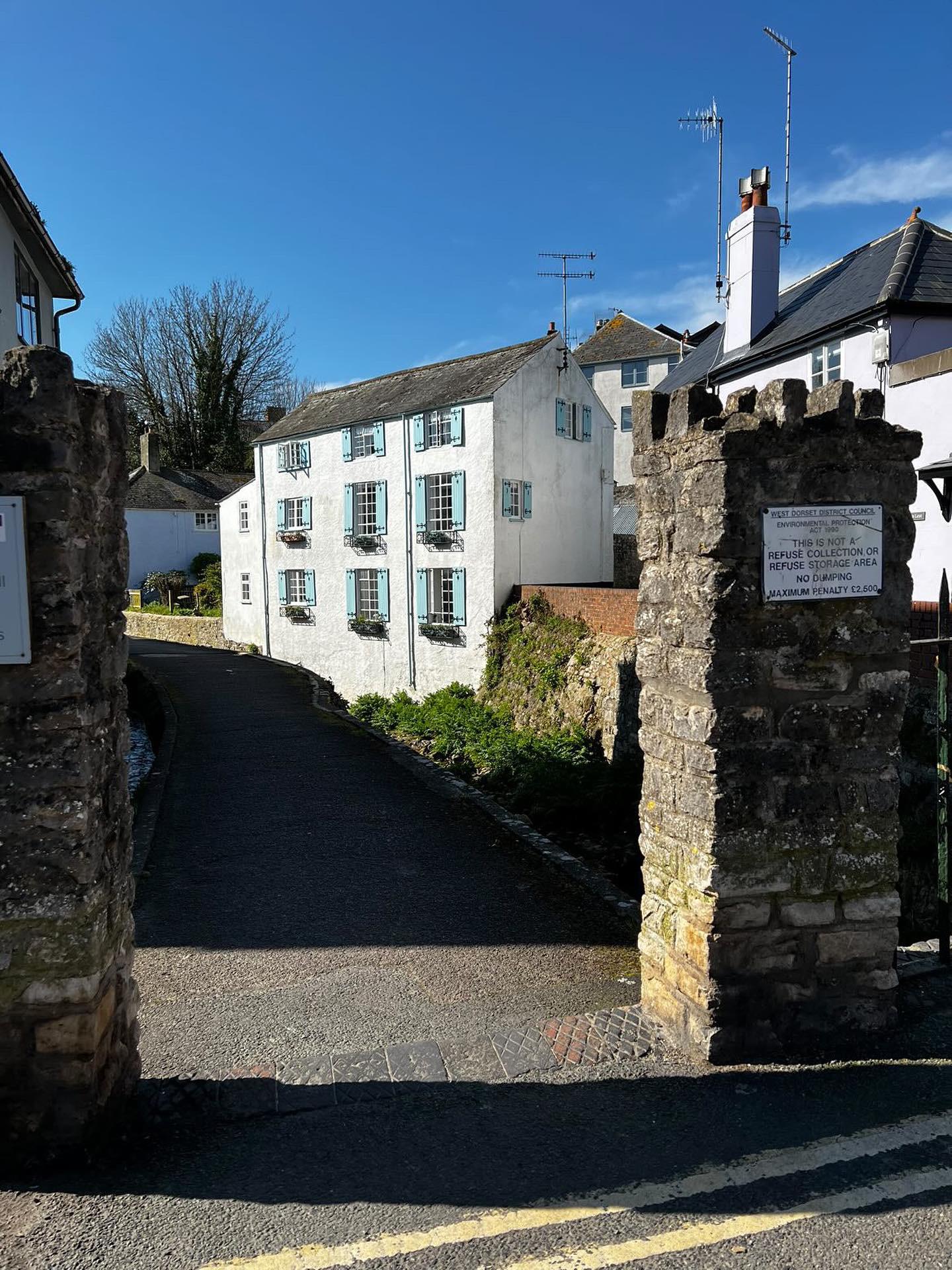 View from the the bridge over the river looking at the majestic mill house that has Waterside holiday apartment within it on the second and third floor . Tow minutes walk to seaside beach and shops.