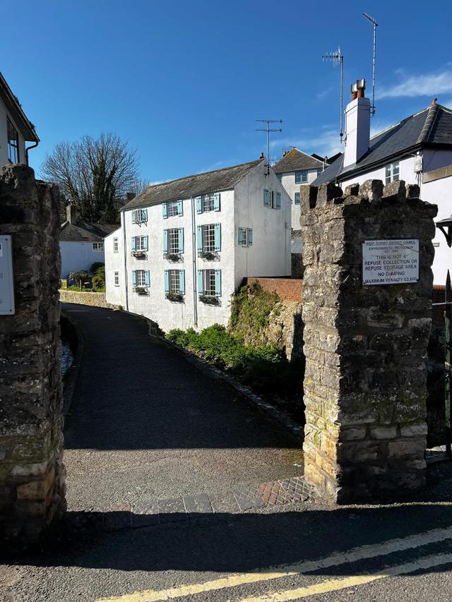 View from the the bridge over the river looking at the majestic mill house that has Waterside holiday apartment within it on the second and third floor . Tow minutes walk to seaside beach and shops.