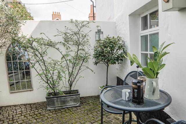 The opposite side of this holiday property to the river side are french doors from the lounge into it's very own private courtyard garden, a perfect holiday stay with privacy