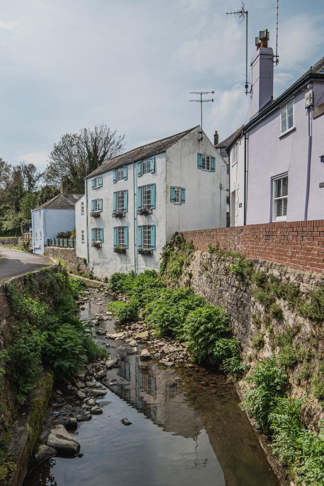 View of the river and the holiday property right next to it nestled around other period cottages in the heart of Lyme Regis prooving you can walk easily two minutes to sea beach and shops