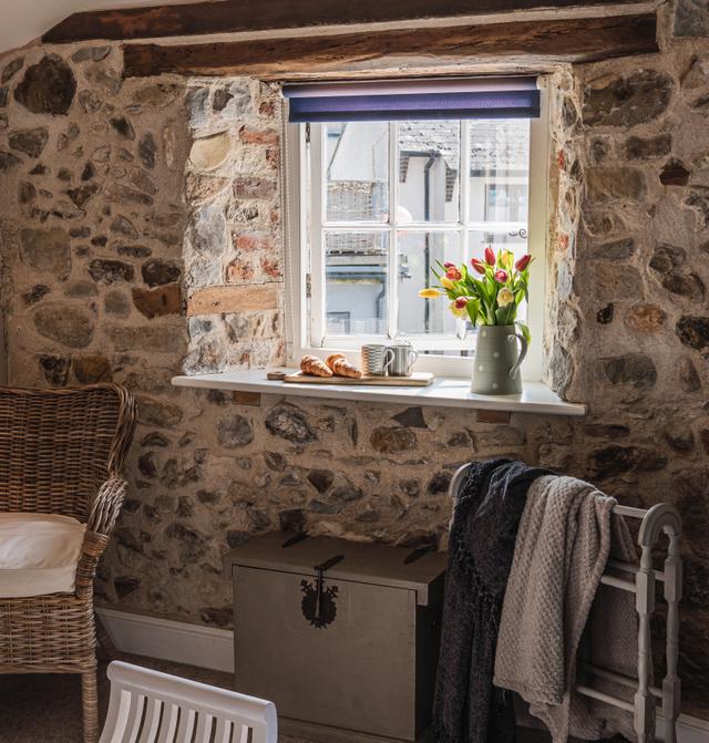 Bedroom window with beautiful interior stone walls, sunlihgt pouring in, read a book or just watch the river running by and the sounds of flowing water,  relax