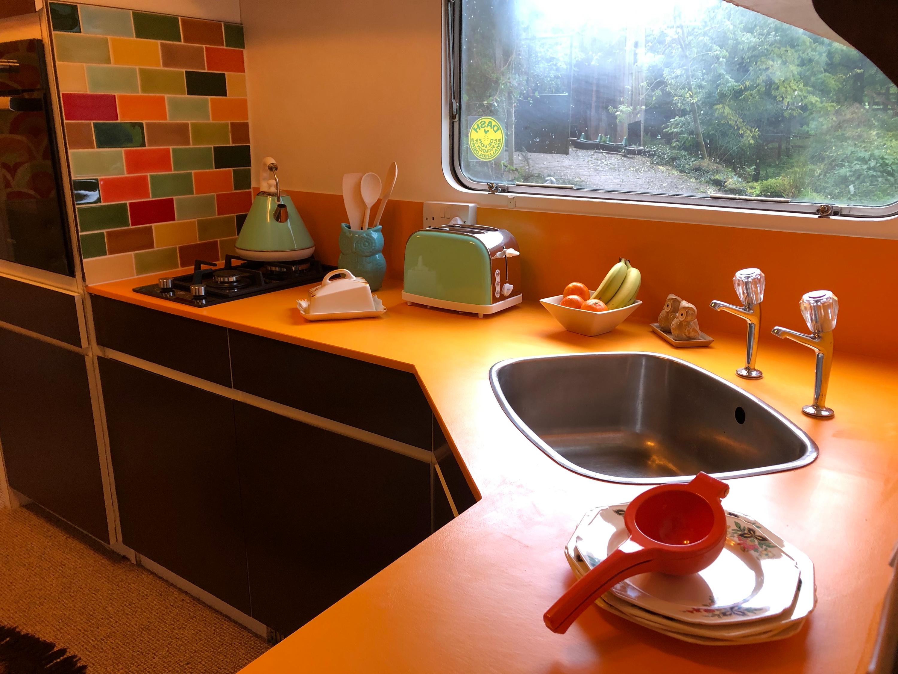 Fully equipped 70s style kitchen with large fridge freeze, gas hob and electric oven