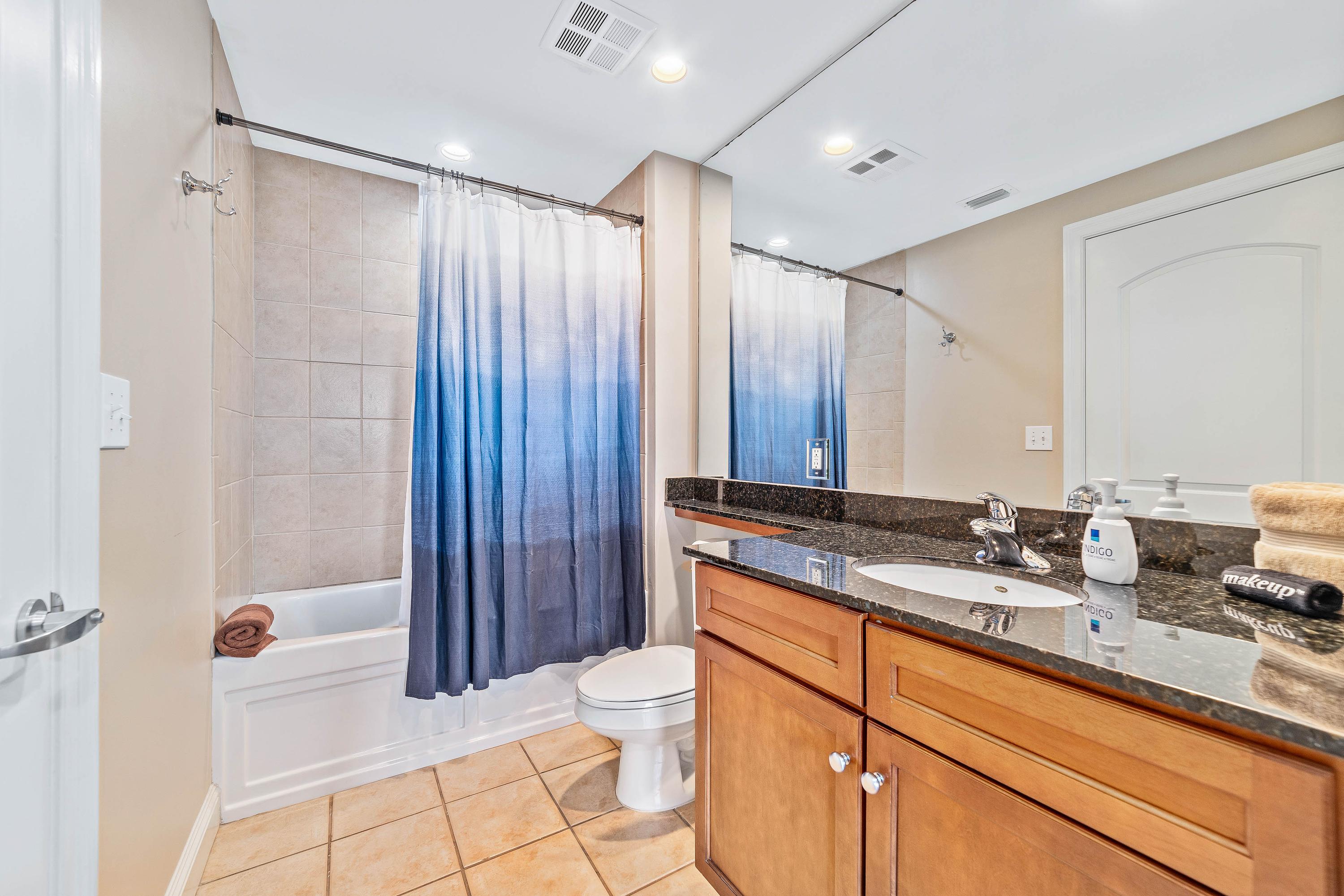 Bath with tub and shower, adjacent to guest room, and hallway