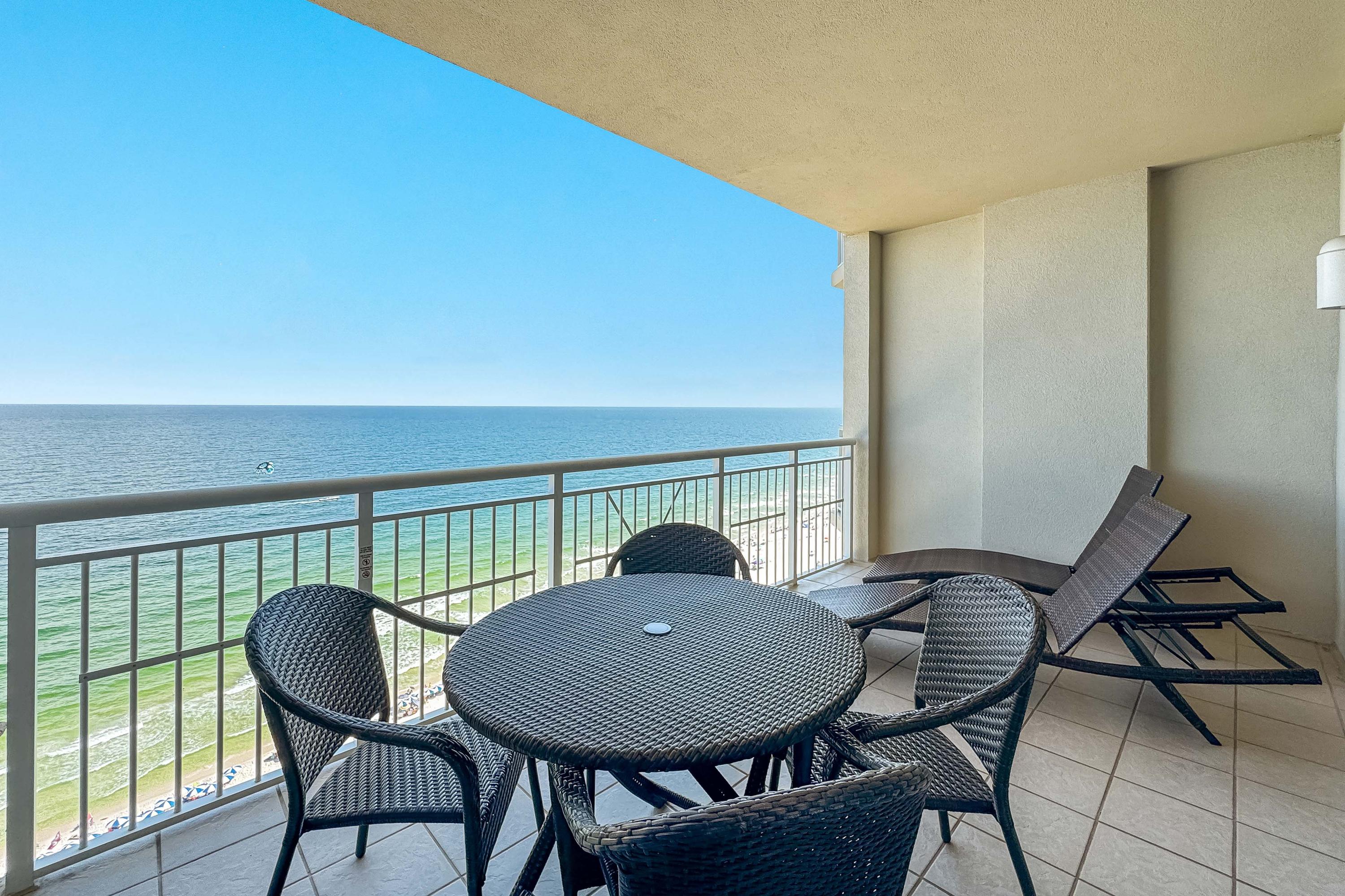 Gulfside Balcony features dining table, chairs, and two lounge chairs.