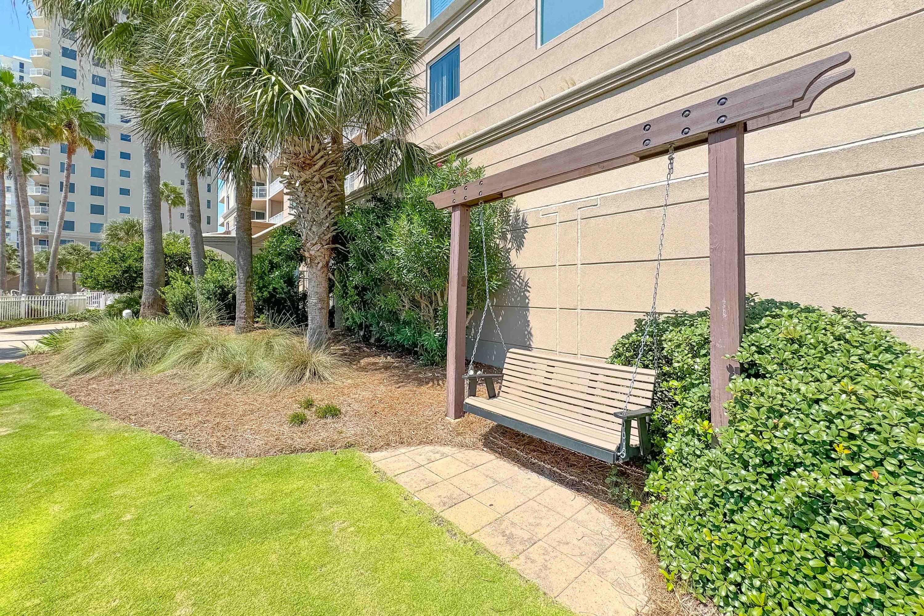 Relax on this swing located near the pool and grilling areas