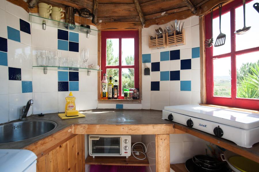 Kitchen area with tiled walls and concrete kitchen top