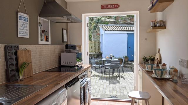 Galley kitchen view to the courtyard garden and seating