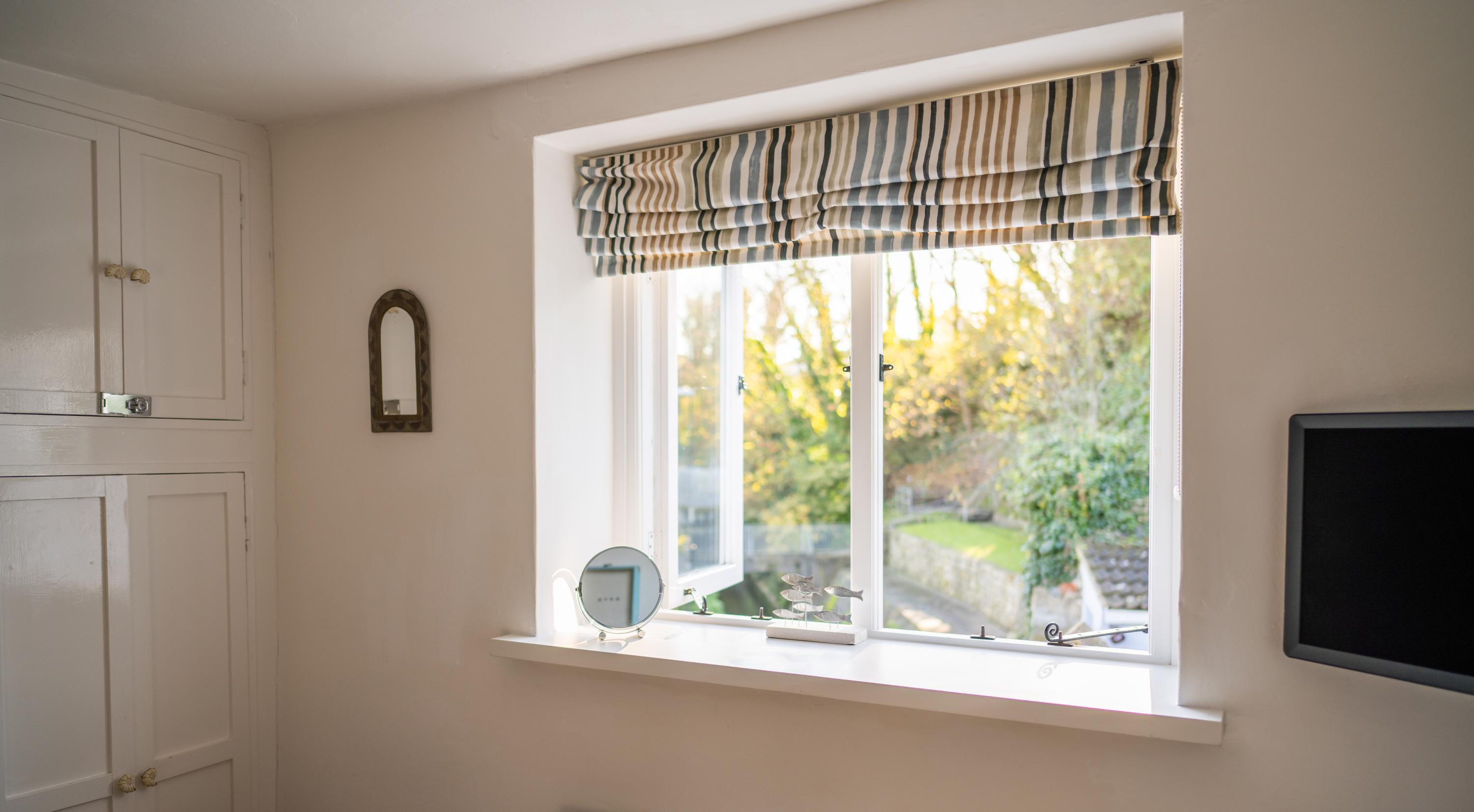 Views from the double bedroom of the courtyard garden and river Lym in this centrally located holiday cottage in Lyme Regis 