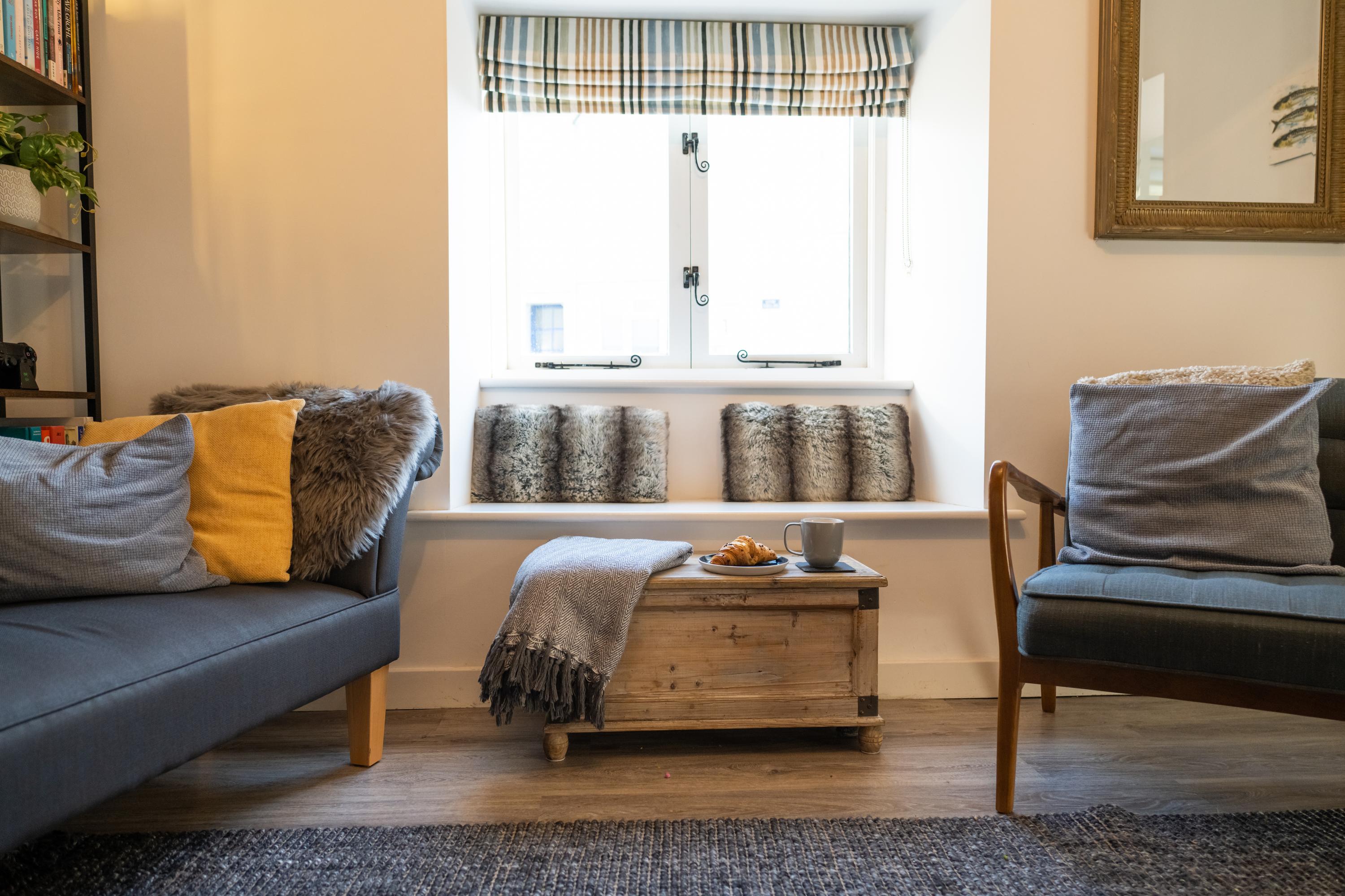 Lounge views with double windows opening over the river Lym with views of the river sit on the contemporary scadi style sofa window seat or chaise longue