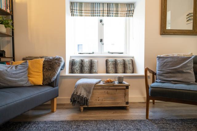 Lounge views with double windows opening over the river Lym with views of the river sit on the contemporary scadi style sofa window seat or chaise longue