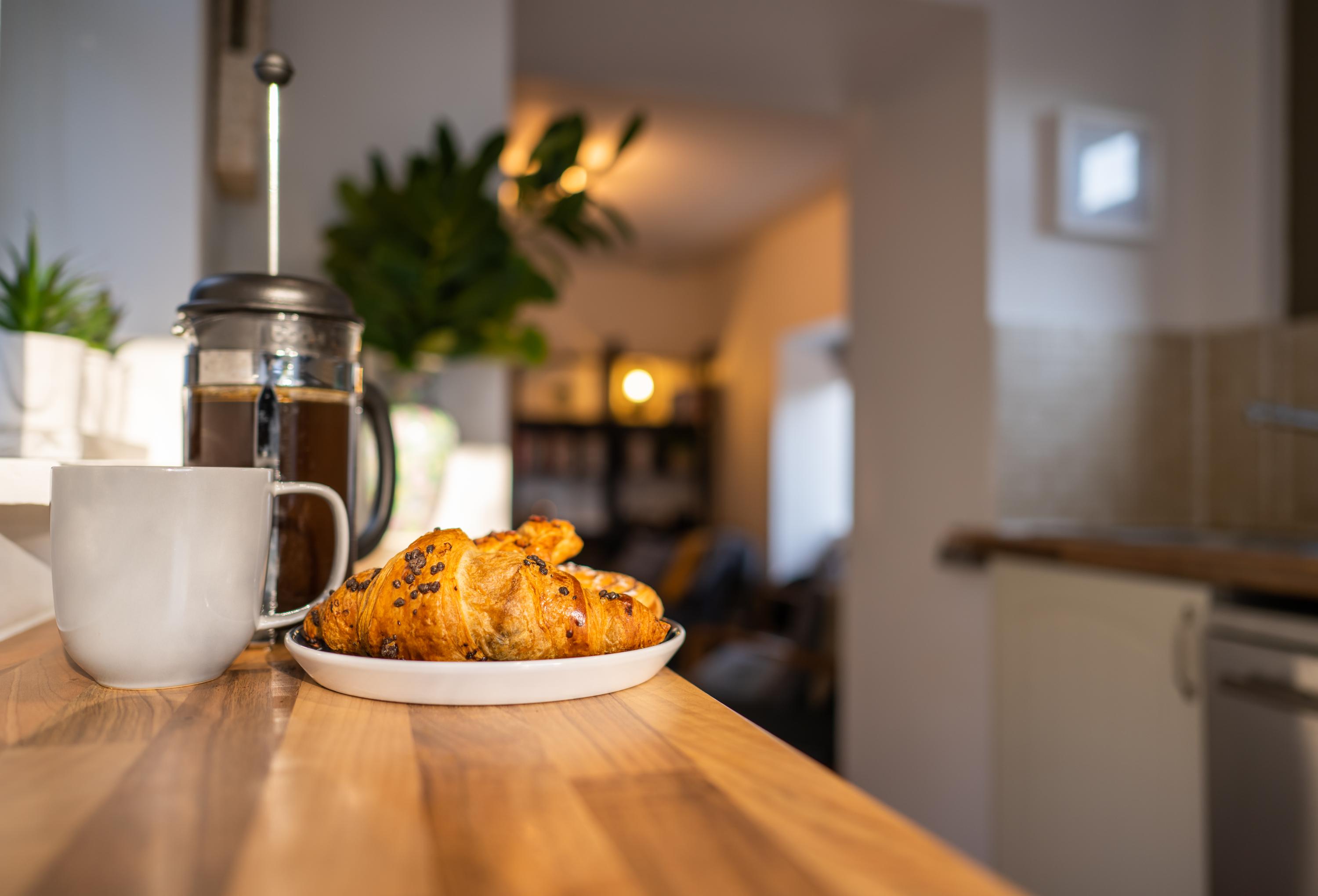 Enjoy breakfast lunch or dinner in this case breakfast with this galley kitchen kitchen top and stools where the sunlight shines in from the garden 