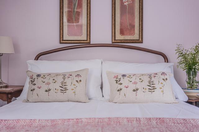 Second double bedroom at the holiday property Starch Mill in Lyme Regis Dorset. The pink bedroom with en suite and newly decorated with views over the River Lym and gardens