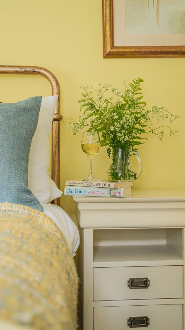 Relax in bed with a book in this happy bedroom, family holiday home 