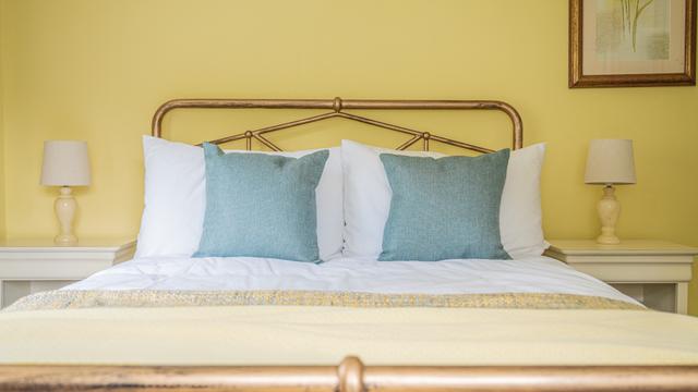 First of the bedrooms in this large warm holiday home. This is the French country garden bedroom with double bed, views over the garden and the river Lym and second waterway 'the Lynch' in central Lyme Regis 