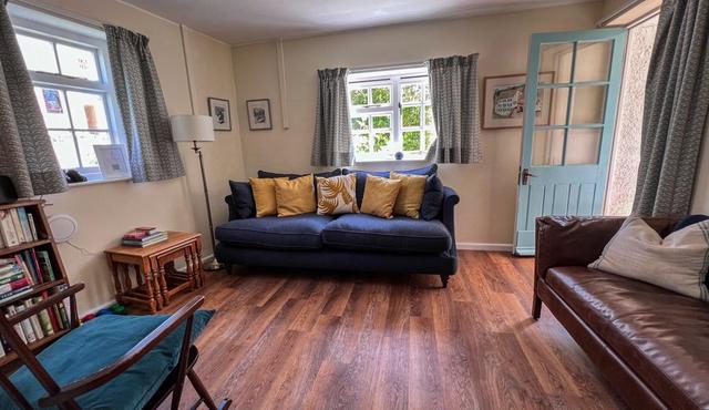 The lounge at Starch Mill, pet friendly, views of the garden and door to garden, wo sofas and netflix TV, John Lewis sofas