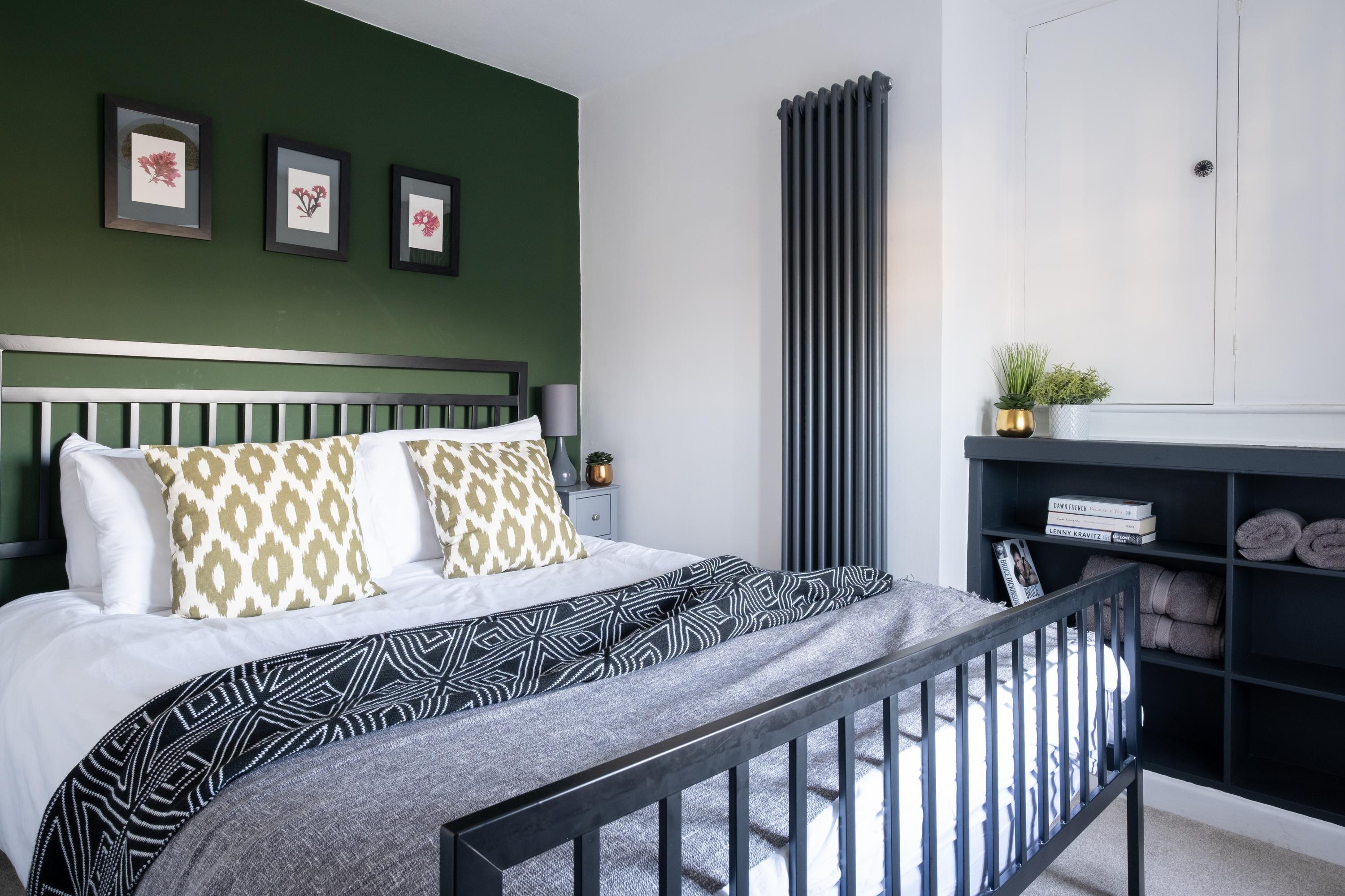 King size bed in the cosy bedroom of this 250 year old cottage with contemporary stylish interior bedroom design 
