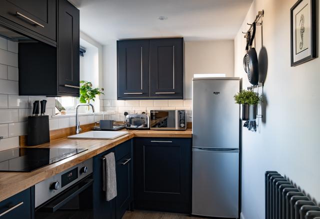 Recently decorated kitchen with modern and stylish kitchen interiors within this holiday property in central Lyme Regis