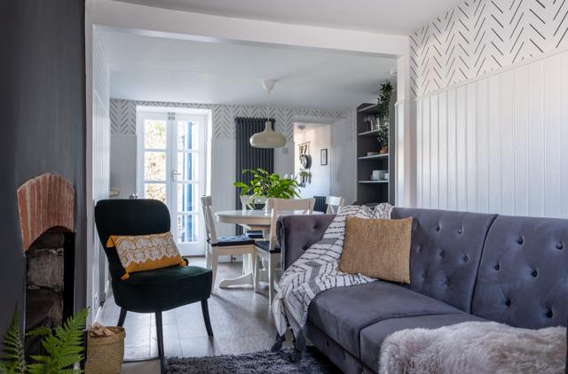 Lounge comfy sofa easy chair and dining table with overhanging mood giving light for a perfect modern stylish living in this holiday cottage in central Lyme Regis