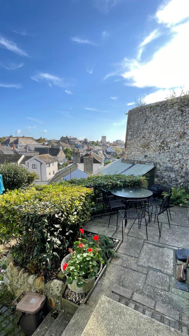 Seahorse Cottage courtyard garden near the sea with old walled gardens table and chairs outside 