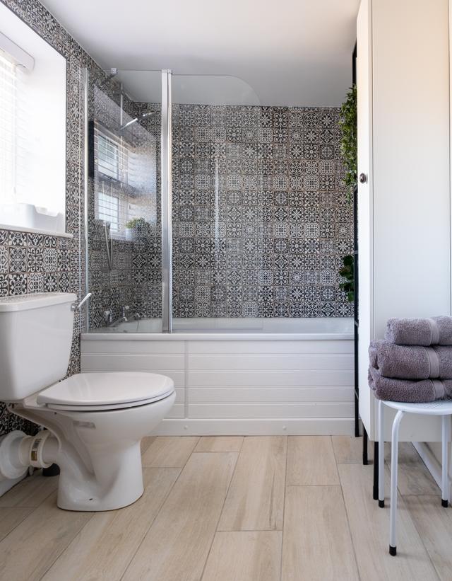 Spacious bath and shower room with stylish bathroom interior plenty of cupboard space and light from the first floor window of this holiday let in central Lyme Regis
