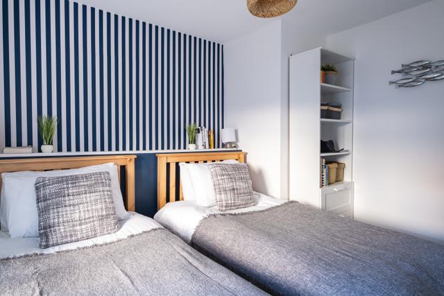 Twin bedroom on first floor with stylish bedroom interior design in this period and characterful holiday cottage in central Lyme Regis 