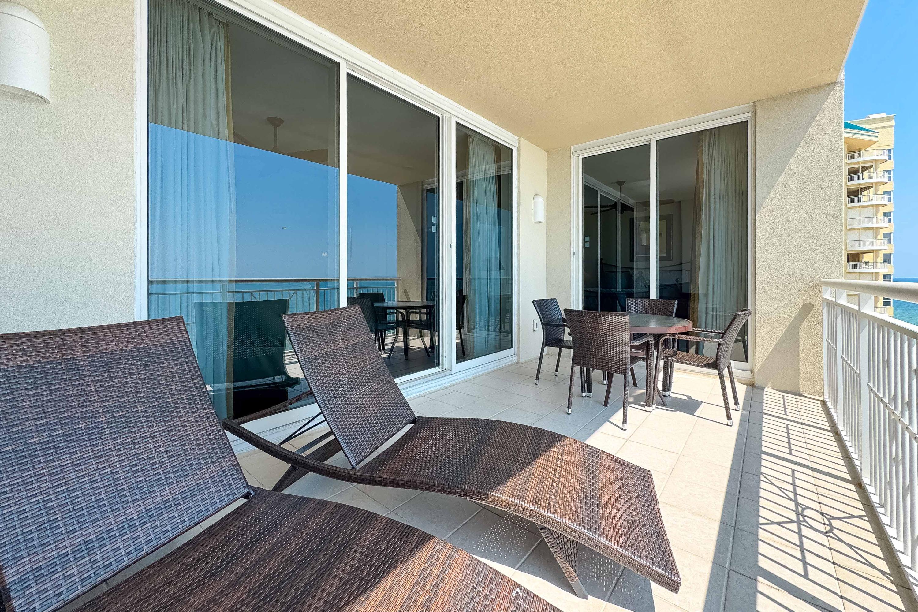 Gulfside Balcony features dining table, chairs, and two lounge chairs.