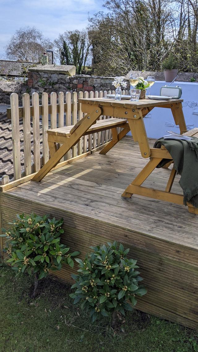 Garden picnic table with decking and river views of the River Lym in Lyme Regis