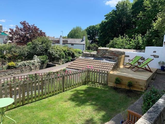 Garden with outside seating and river views at this characterful period cottage holiday stay at Lym River