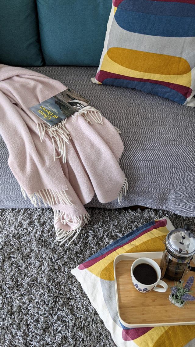 Sofa blankets and footstool in the lounge at Lym River holiday cottage 