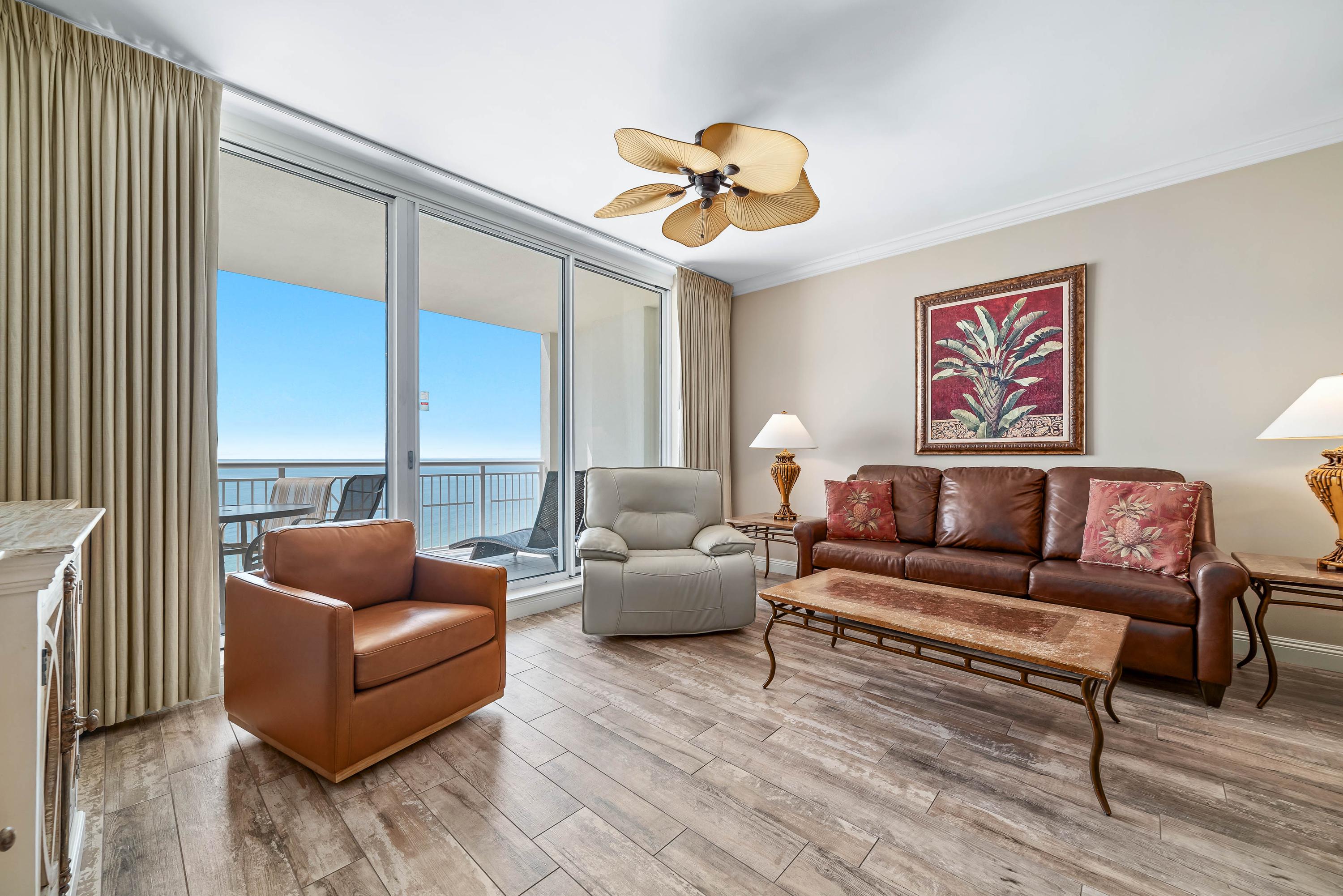 Living room area with leather furniture, including a motorized recliner.
