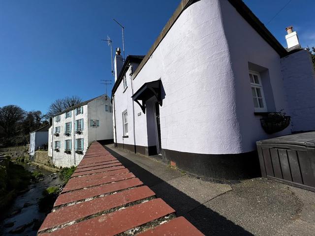 River side view of the exterior of Lym Leat one bedroom holiday property in central Lyme Regis
