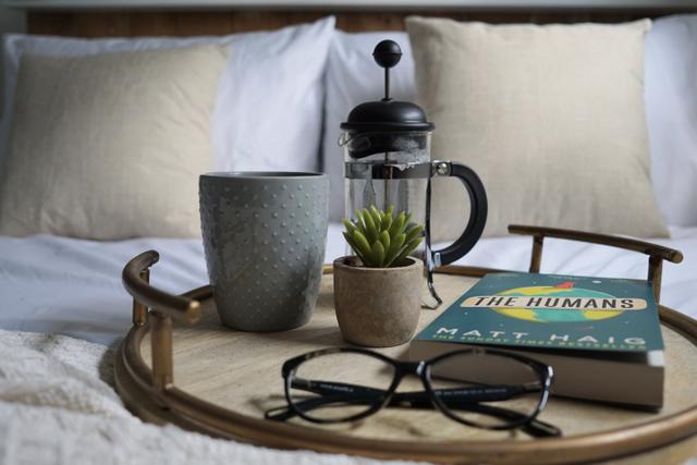 King size bed with wall lights here showing breakfast in bed with river views