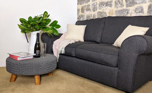 Comfy sofa and footstool in the living room of Lym Leat Holiday home in Lyme Regis