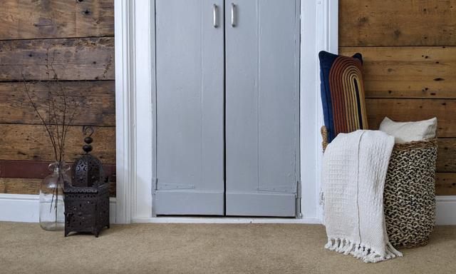 Bedroom with wood sleeper clad wall and double door walk in cupboard wardrobe