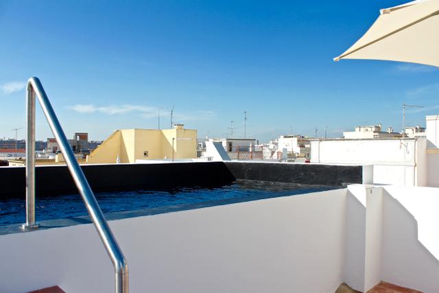 Rooftop swimming pool at Casa Opala overlooking Olhão rooftops